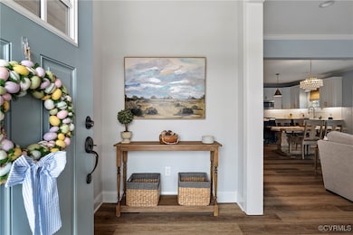 Foyer entrance featuring ornamental molding, wood