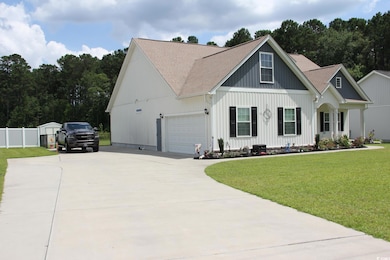 Modern farmhouse style home featuring driveway, a shingled roof, an attached garage, and board and batten siding