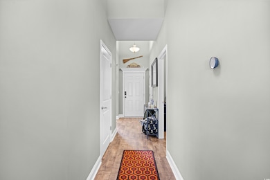Hallway with light wood-style flooring and baseboards