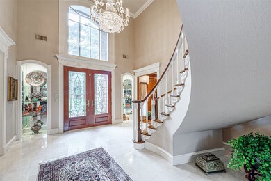 The foyer features lead glass front doors with bea