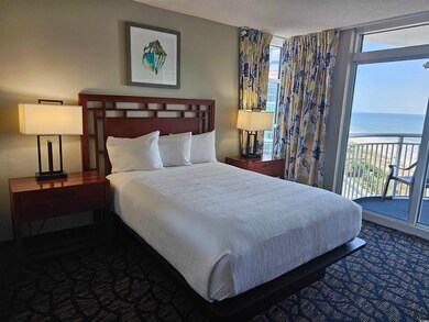 Bedroom with multiple windows, access to exterior,