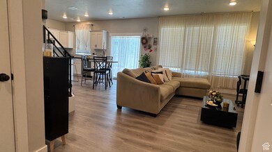 Living room featuring light wood finished floors and recessed lighting