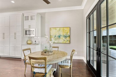 French doors lead to large back deck with view of 