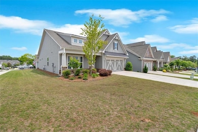 Craftsman-style house with concrete driveway, boar