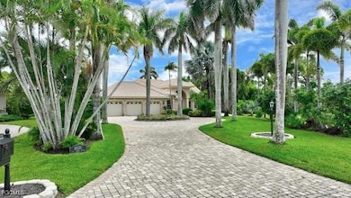 View of front of property with a front lawn, a garage, and decorative driveway