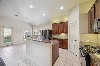 Spacious kitchen with breakfast bar island.