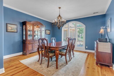 Dining room with a chandelier, hardwood floors is large enough for all your gatherings!