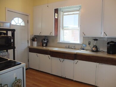 Kitchen has a serving window and solid surface cou