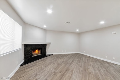 Unfurnished living room featuring visible vents, b