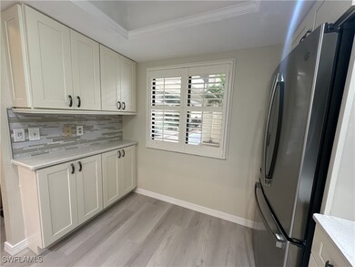 Kitchen featuring tasteful backsplash, a raised ce