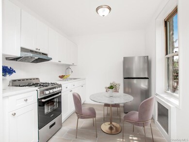 Kitchen with stainless steel appliances, under cabinet range hood, healthy amount of natural light, and a sink