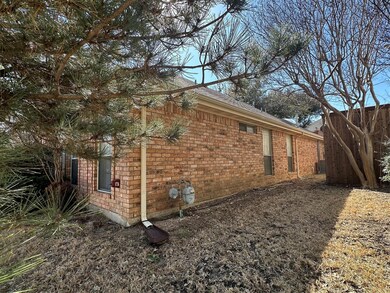 View of home's exterior featuring brick siding, fe