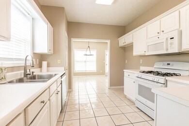 Kitchen with sink, white appliances, white cabinet
