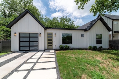 Modern farmhouse style home featuring board and batten siding, driveway, and a garage