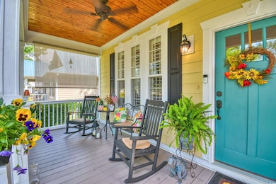 Wooden terrace featuring a porch and a ceiling fan