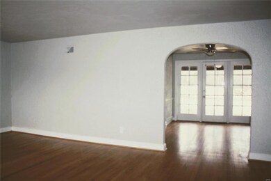 The living room opens into a light-filled dining room that overlooks the back yard.
