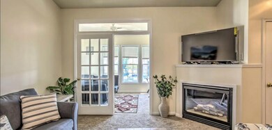 Carpeted living room featuring a glass covered fir