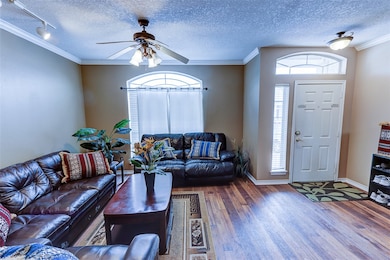 Living area with wood finished floors, a ceiling f