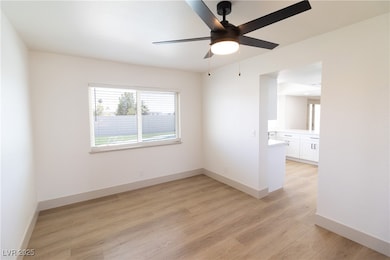 Spare room with light wood-style floors, baseboard