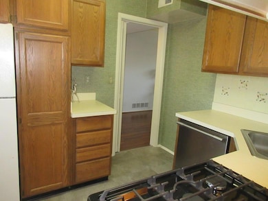 Kitchen featuring visible vents, dishwasher, light