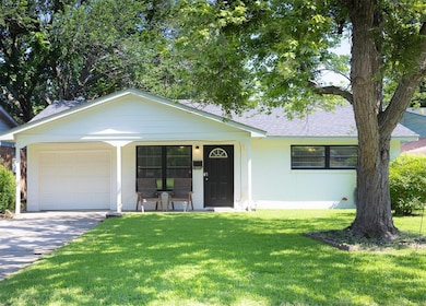 View of front of home with a porch, a front yard, concrete driveway, roof with shingles, and an attached garage