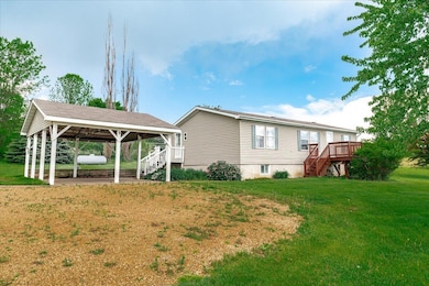Covered car port which also makes a great patio and entertaining space
