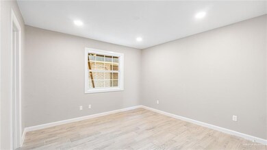 Bedroom with light wood style floors and recessed lighting