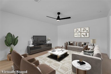 Living room featuring a ceiling fan and light wood finished floors