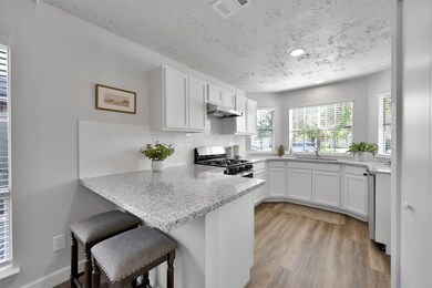 The half wall in the kitchen was lowered to counter height, opening the space and making this is a great spot for a morning cup of coffee or a quick meal on the go!  Additional recessed lighting was added to the kitchen making it light and bright.
