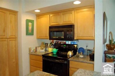 Kitchen has granite counters and maple cabinetry.
