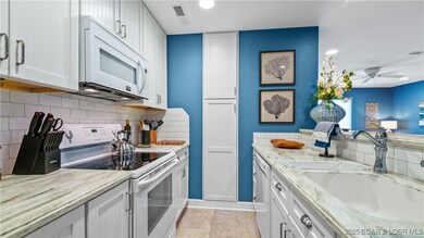 The stylish galley kitchen features unique quarts