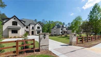 French country home with fence, a front lawn, ston