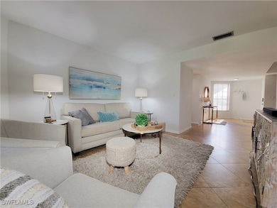Living room with light tile patterned flooring