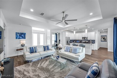 Living room featuring a tray ceiling, wood pattern