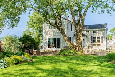 Rear view of 105 River Road with family room entrance thru sliders.