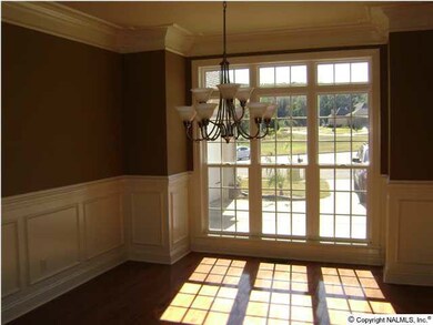 Formal dining room with heavy crown molding and large windows for plenty of sun light. Note the quality of the hardwood floors.