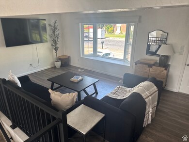 Living room with wood finished floors and baseboards