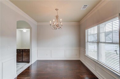 Unfurnished dining area featuring crown molding, a