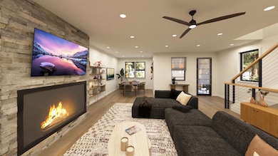 Living area featuring light wood-style flooring, a fireplace, recessed lighting, and ceiling fan