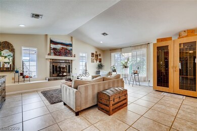 Formal living room with gas fireplace and vaulted