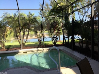 Outdoor pool with a lanai and a water view