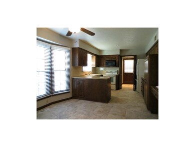 Kitchen has new tile floors, ceiling fan, blinds, 