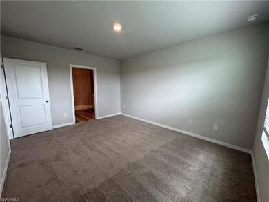 Unfurnished bedroom with carpet floors and ensuite bathroom