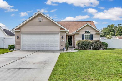 Ranch-style house with a garage and a front lawn