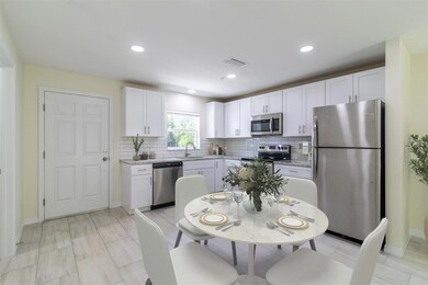Spacious kitchen with stainless steel appliances and granite counters + pantry. Staged picture.