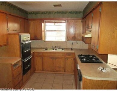 Kitchen. Tile floors and lots of cabinets.