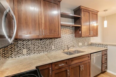Kitchen with open shelves, appliances with stainl