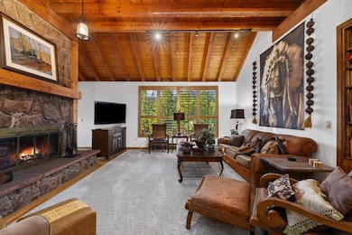 Living room with wood ceiling, carpet flooring, a