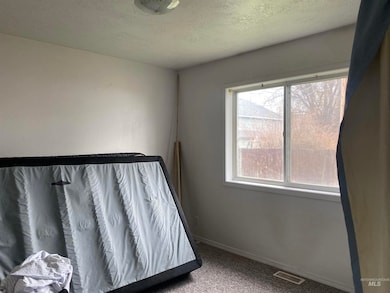 Bedroom featuring carpet and a textured ceiling