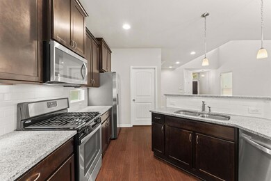 Kitchen featuring appliances with stainless steel